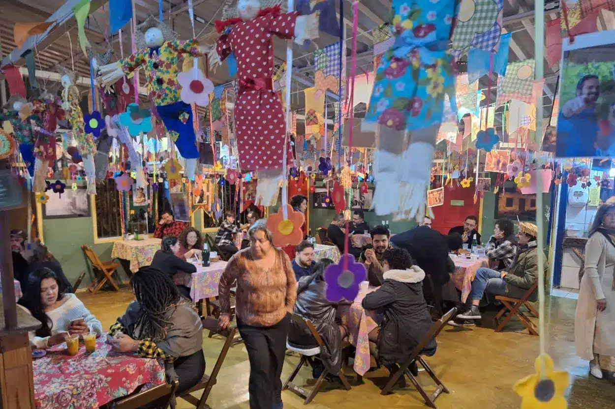 Interior do Bar da Nida, com bandeirinhas e comidas típicas.